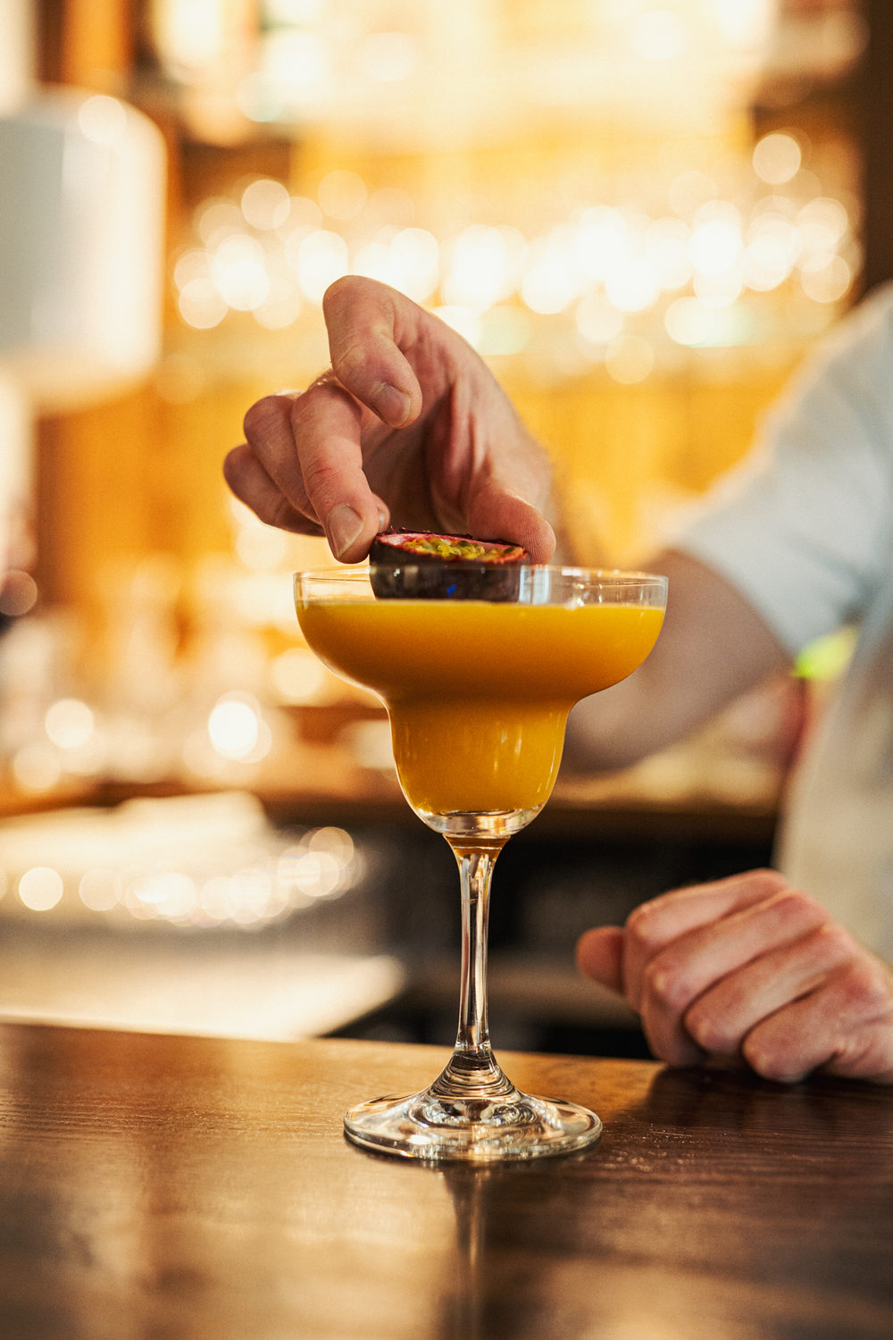 A cocktail being finished at the bar